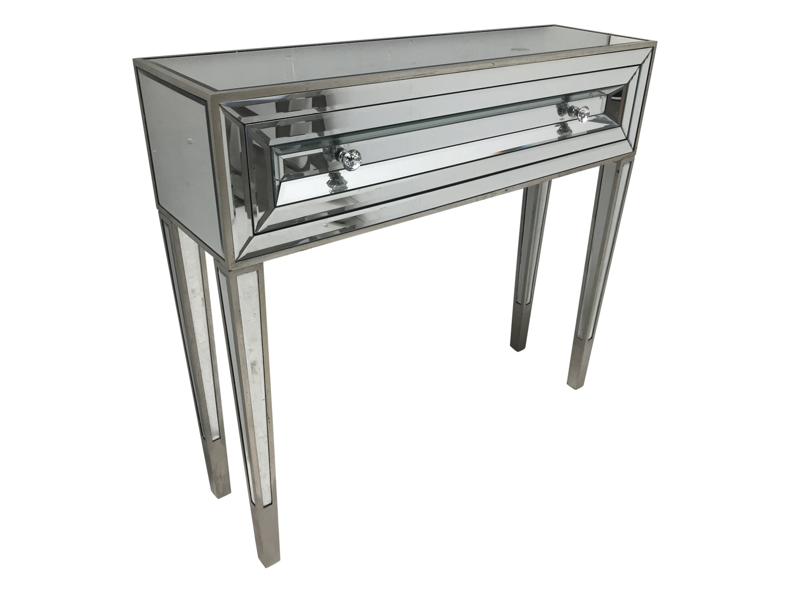 Mirrored console table with one drawer and two diamante handles, front view.