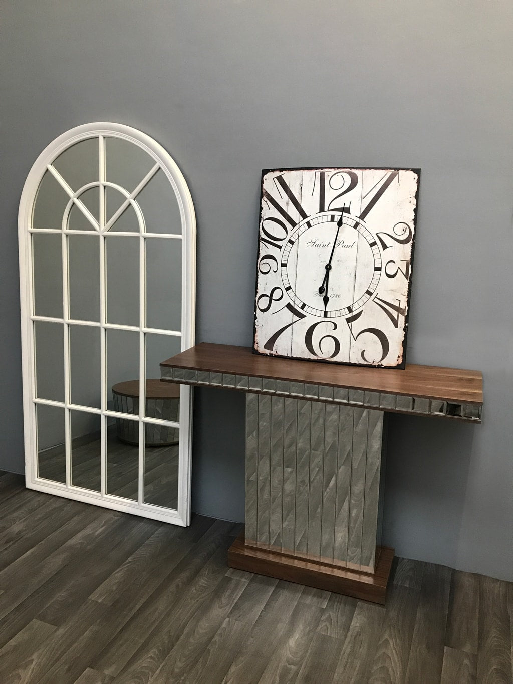 Mirrored Console Table with Walnut Wooden Top arranged with wall clock on top standing to a white window mirror on the left