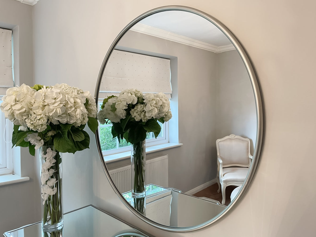 Silver round metal wall mirror